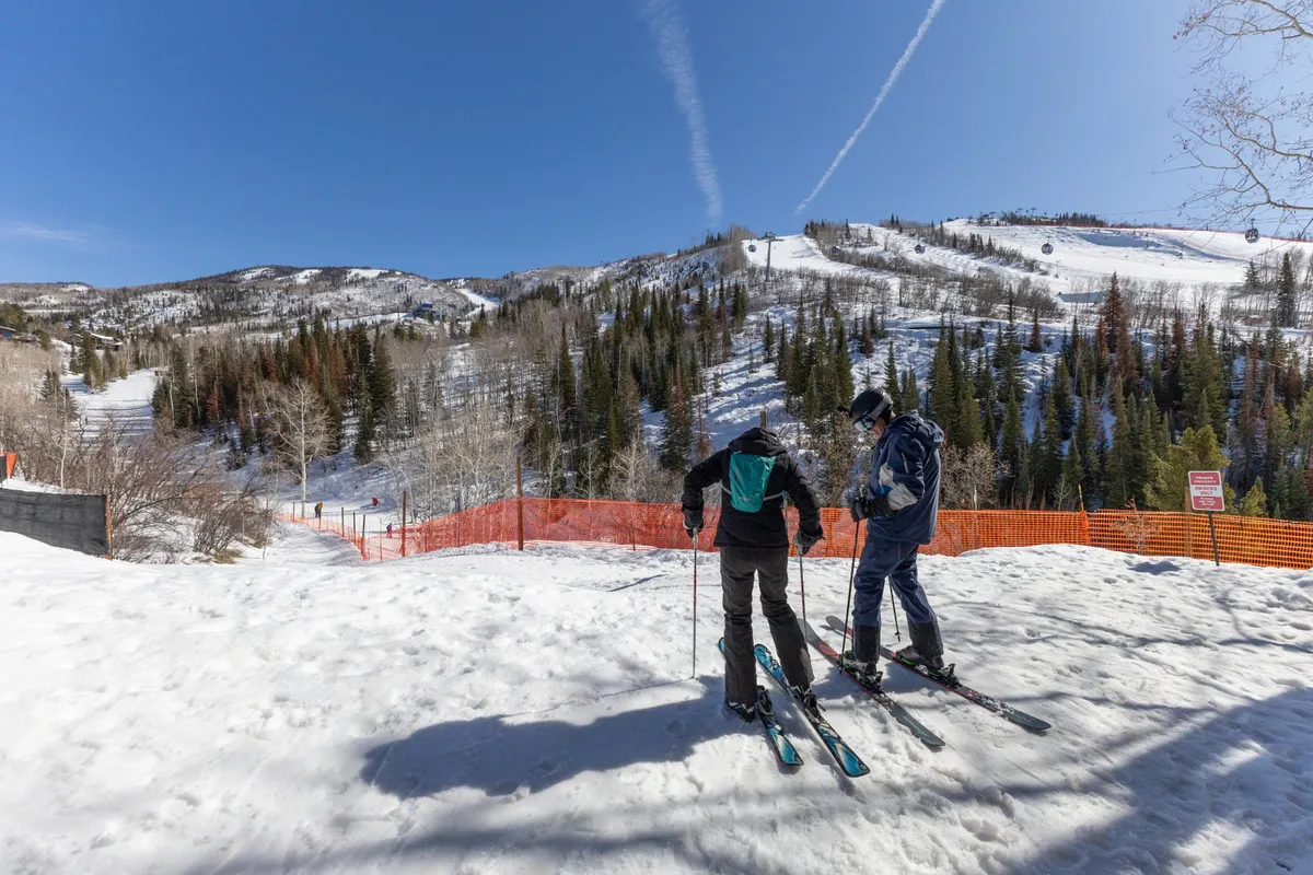 A lively winter scene featuring skiers preparing to descend snowy slopes, distant ski lifts, breathtaking views of snow-capped trees, and the camaraderie of people sharing a mountain adventure. The image radiates excitement and après-ski possibilities.